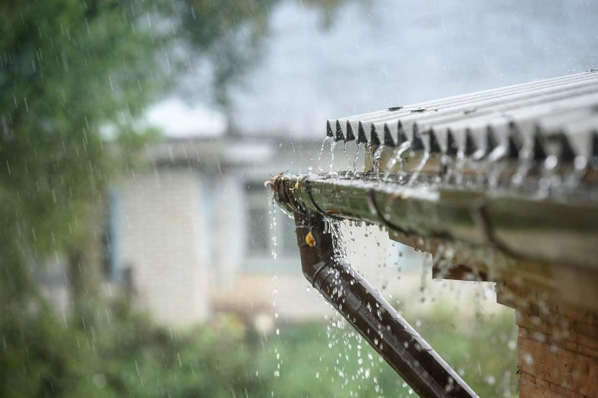 Rain falling of roof into gutter